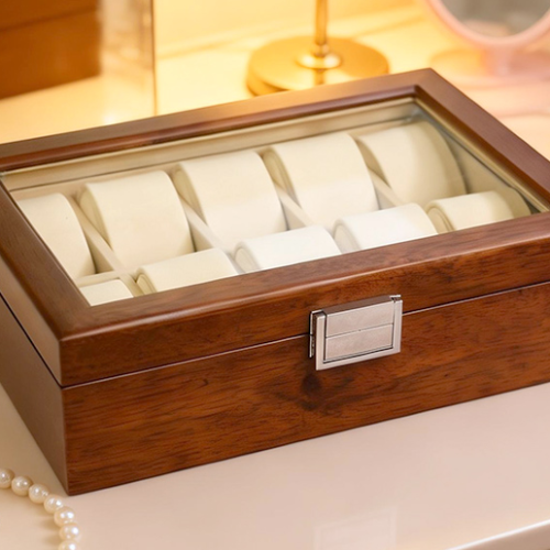 10-slot solid wood watch box with glass lid styled on a dressing table