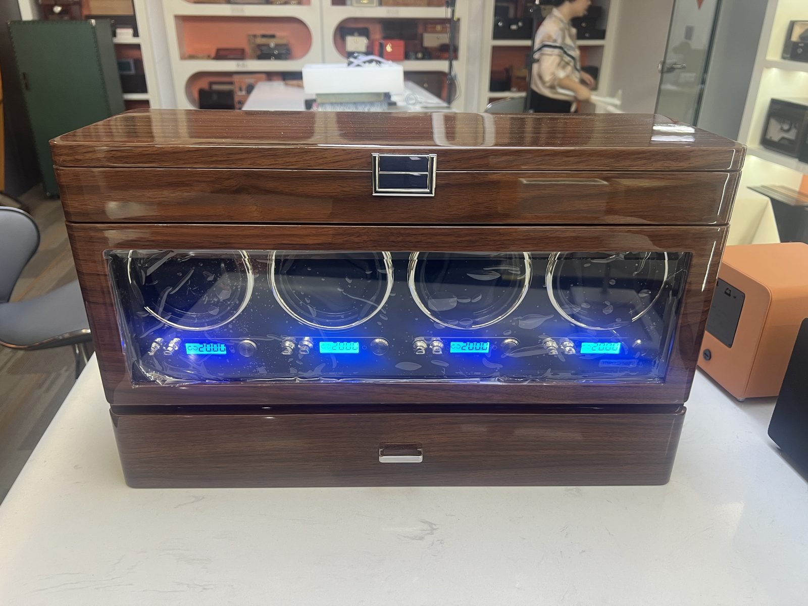 Four-slot walnut watch winder with glass door and per-slot LCD displays