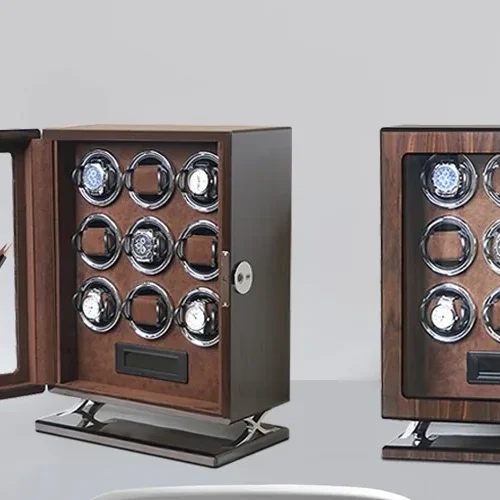 Two nine-slot walnut wood private label watch winder cabinets on a desk, one closed and one with its mirrored glass door open