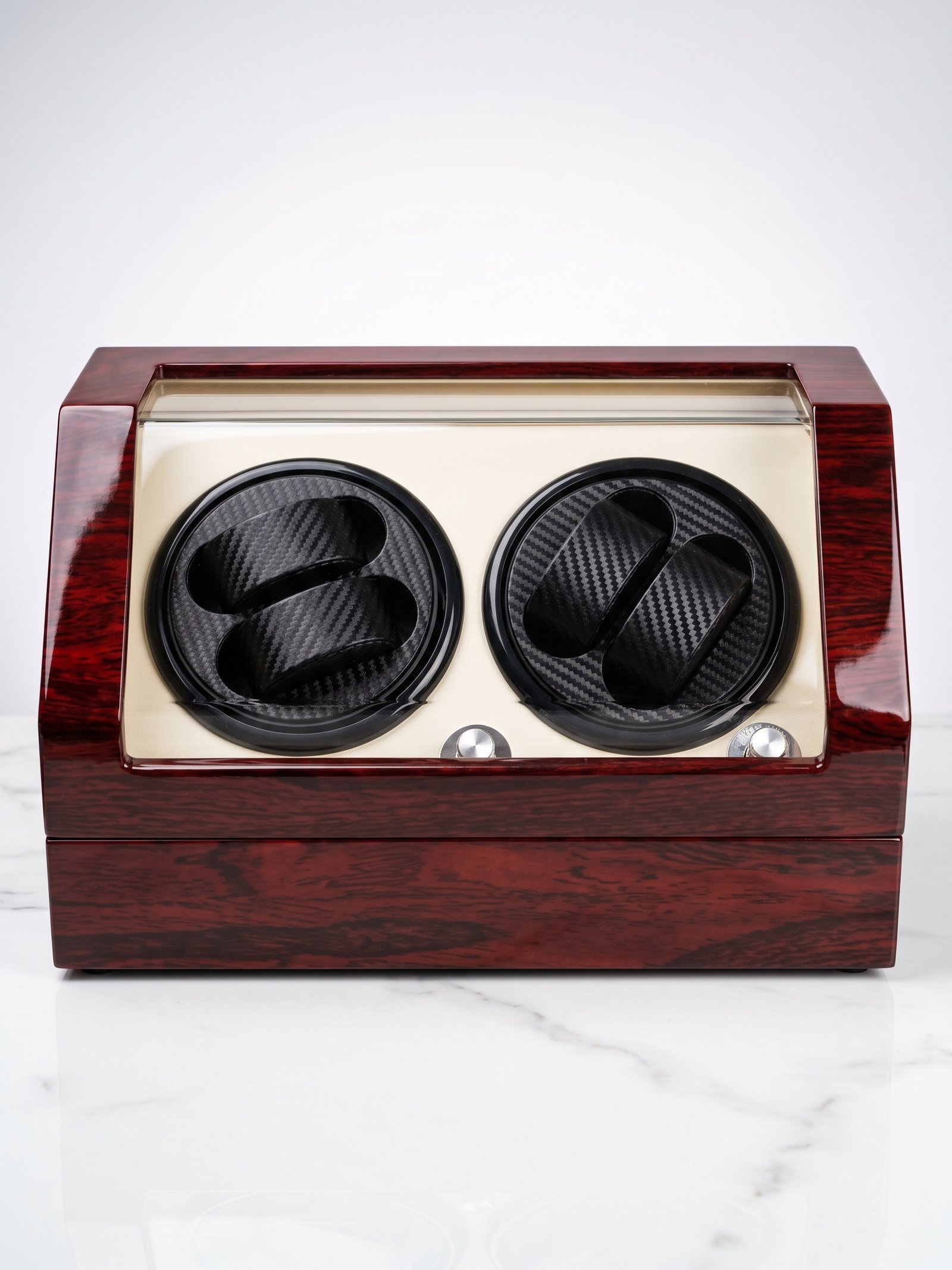 Front view of a red wood two-watch winder with an L-shaped acrylic front and two black carbon-fiber-pattern watch cushions